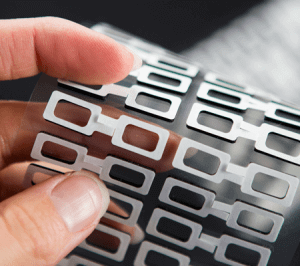 Rotary die cutting with pull tabs