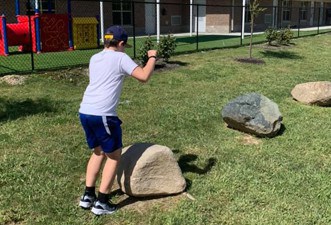 Rocks2 Marian Inc. team building activity involving rock climbing